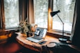 powered-on desk lamp near laptop computer