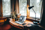 Cozy workspace with editing notes and a laptop displaying a manuscript.