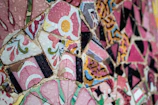 Finished mosaic pieces drying on display boards, glowing with Mediterranean colors.