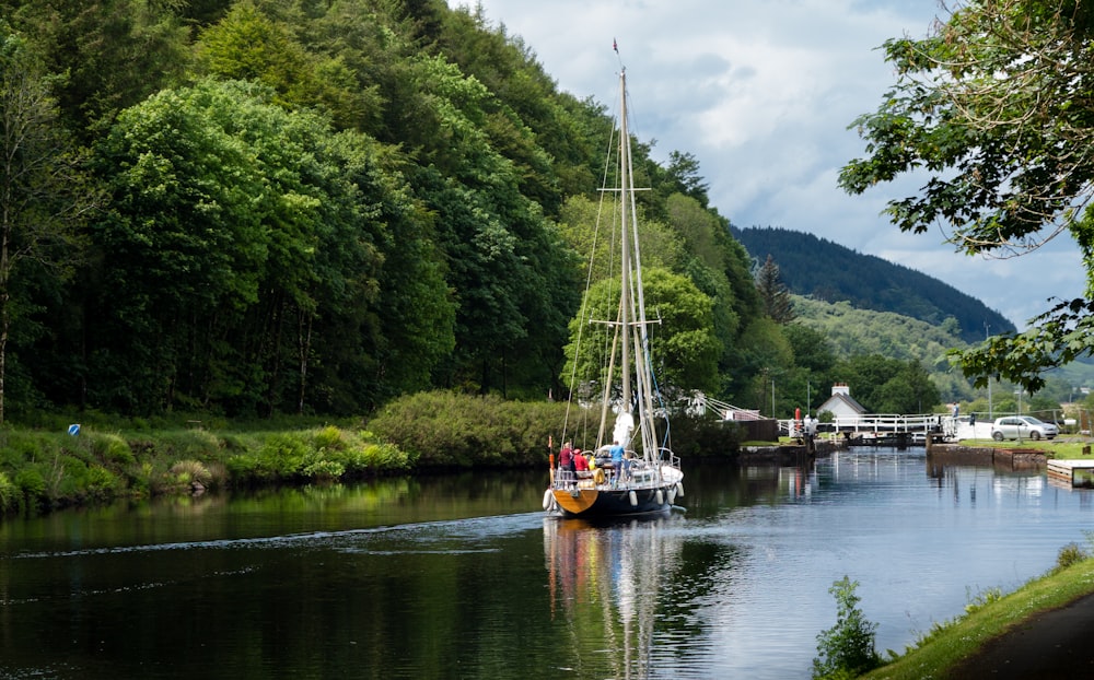 boat in a body of water near a mountain during daytime