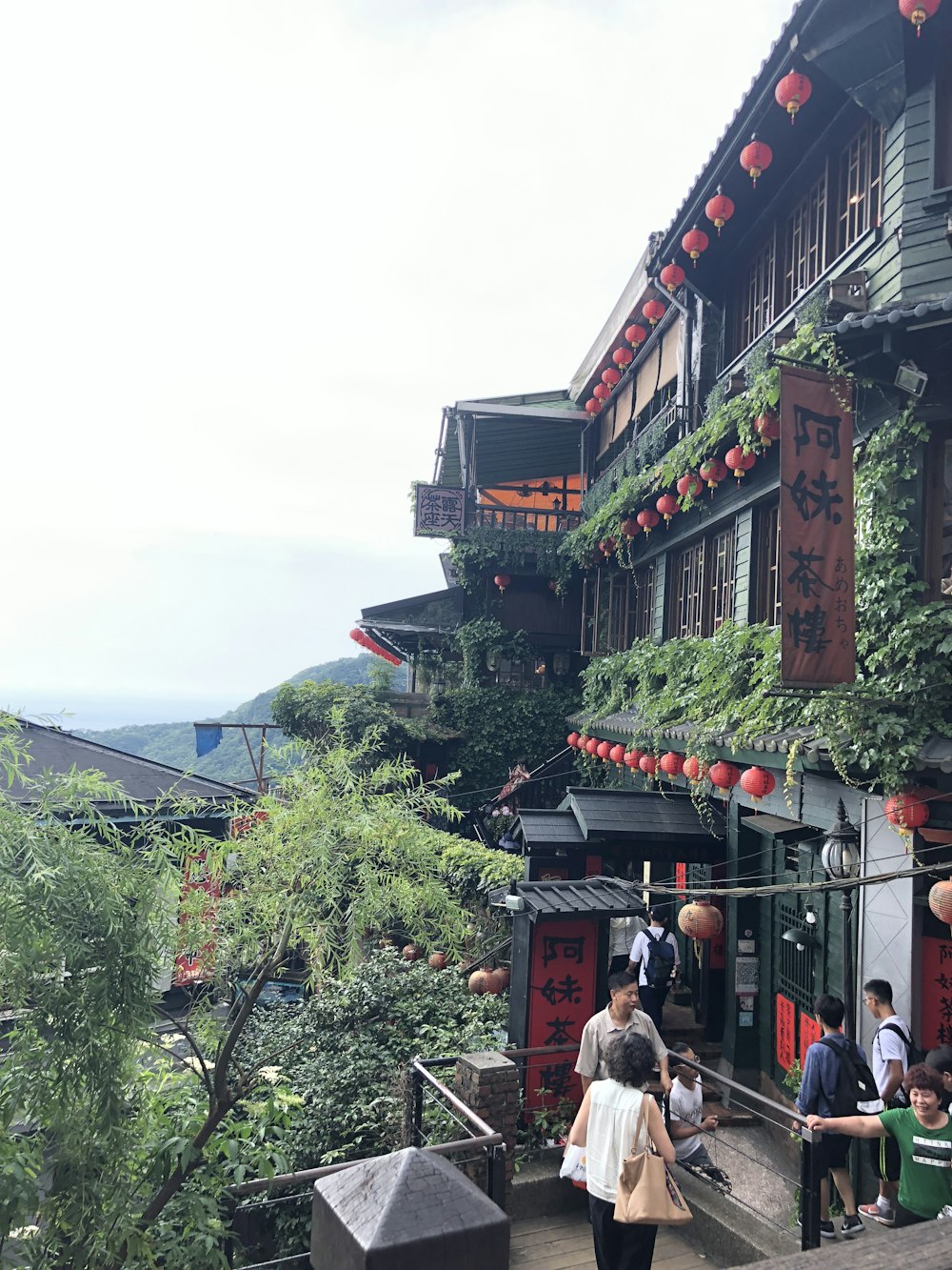 people standing beside house