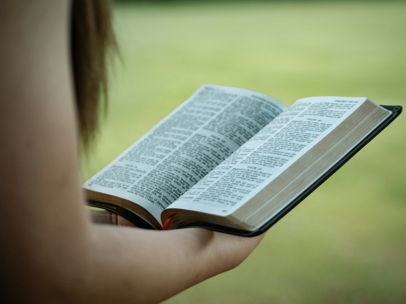 Panasonic Lumix G 42.5mm F1.7 ASPH Power OIS sample photo. Person holding holy bible photography