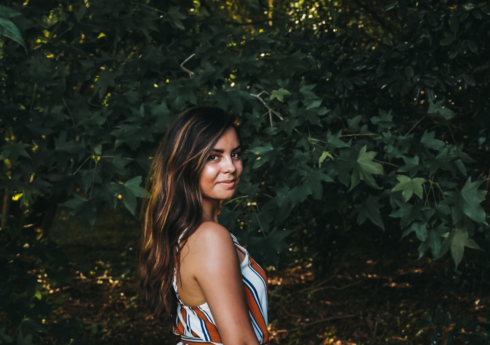 woman in white and red striped sleeveless top