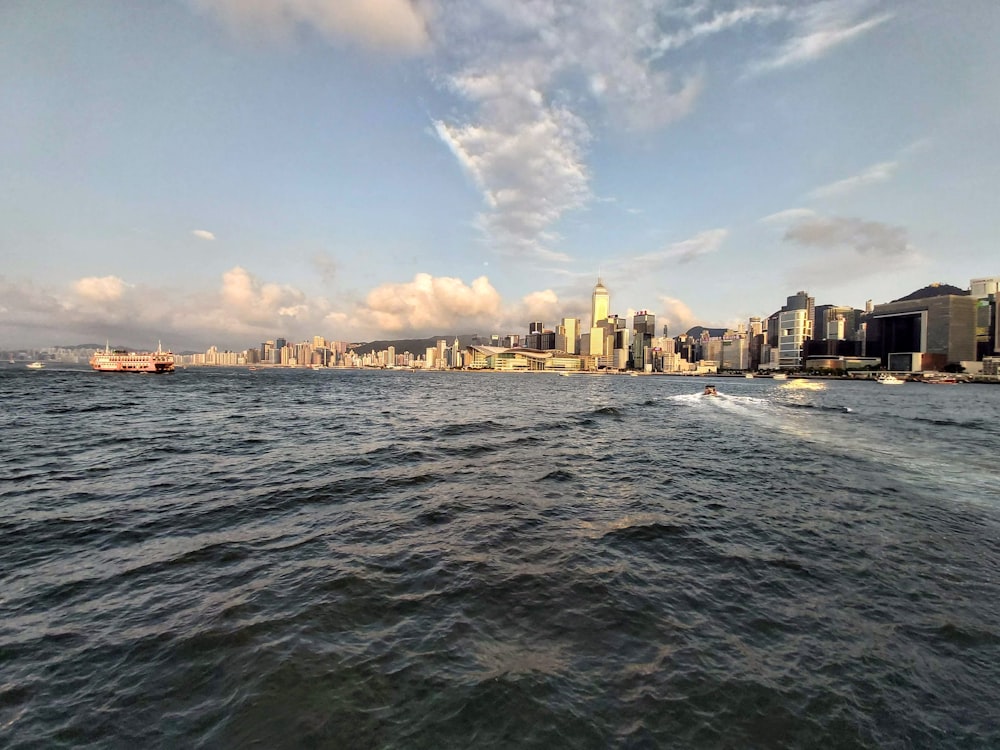 skyline photography of high-rise building beside shore during daytime