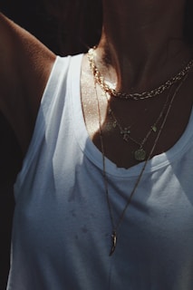 A stylish model wearing personalized jewelry in natural light.