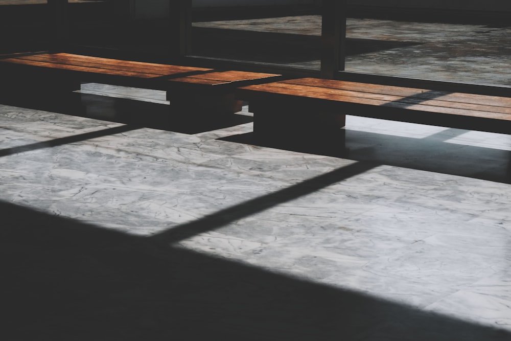 a wooden bench sitting in the middle of a room