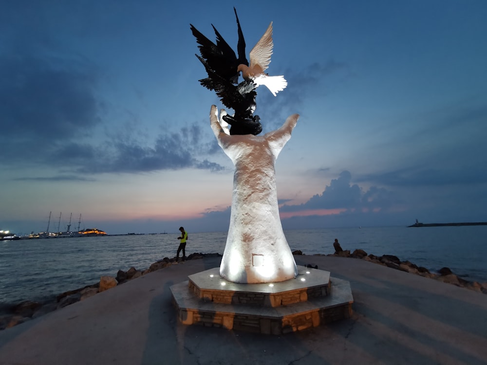 white statue across horizon during nighttime