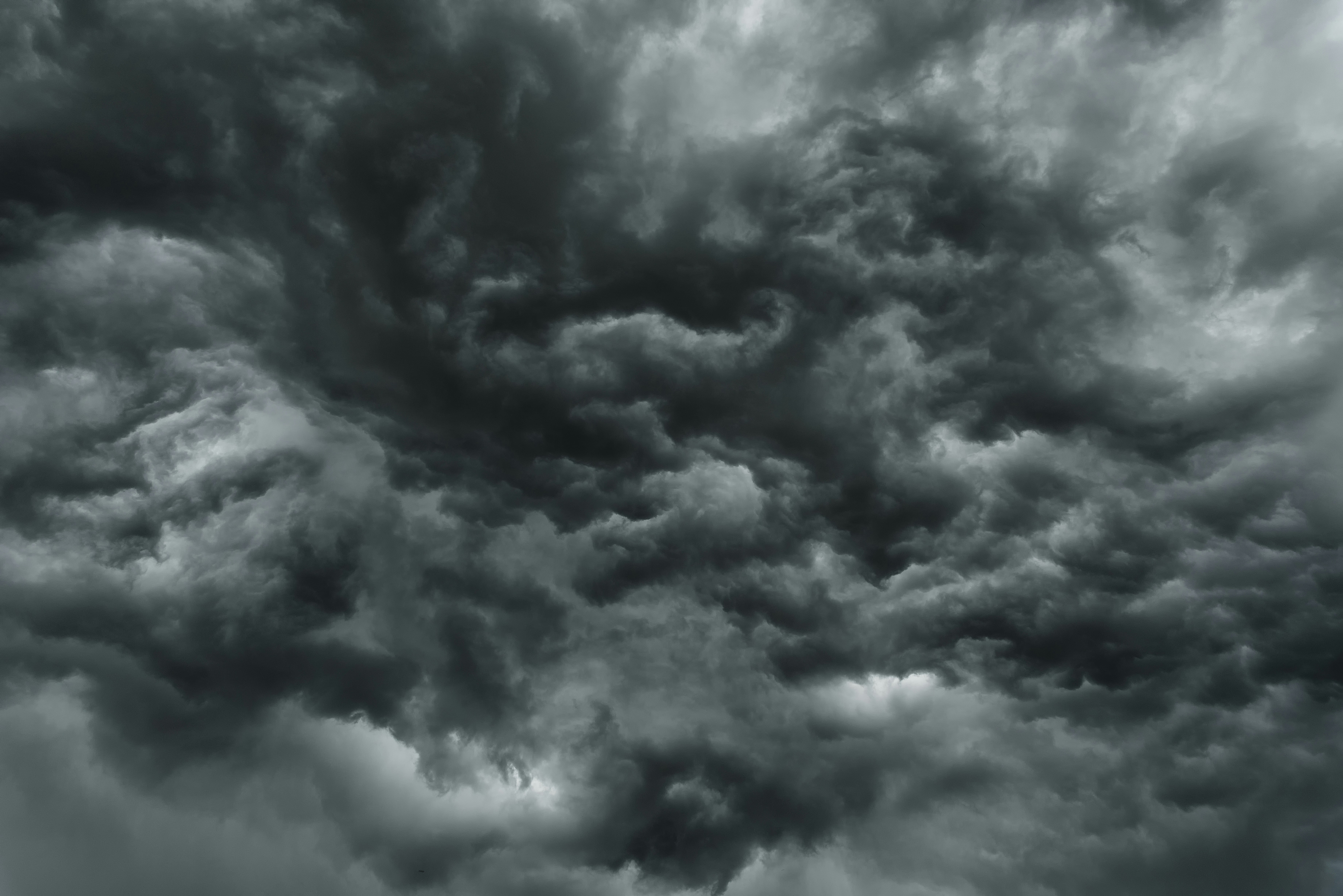 Dense dark grey storm clouds filling the sky with swirling patterns