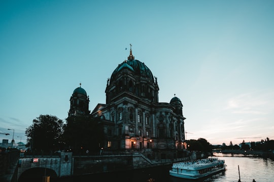 public transportation boat on body of water near cathedral in Berlin Cathedral Germany