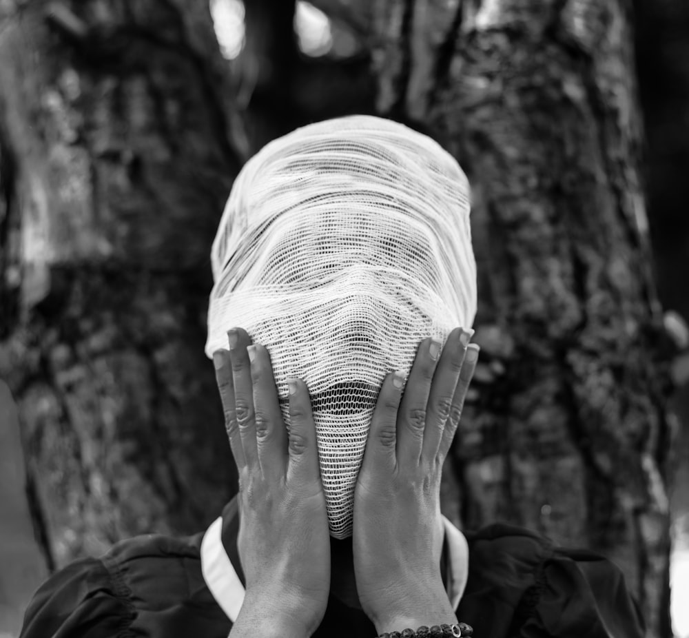 person wrapped face with white textile