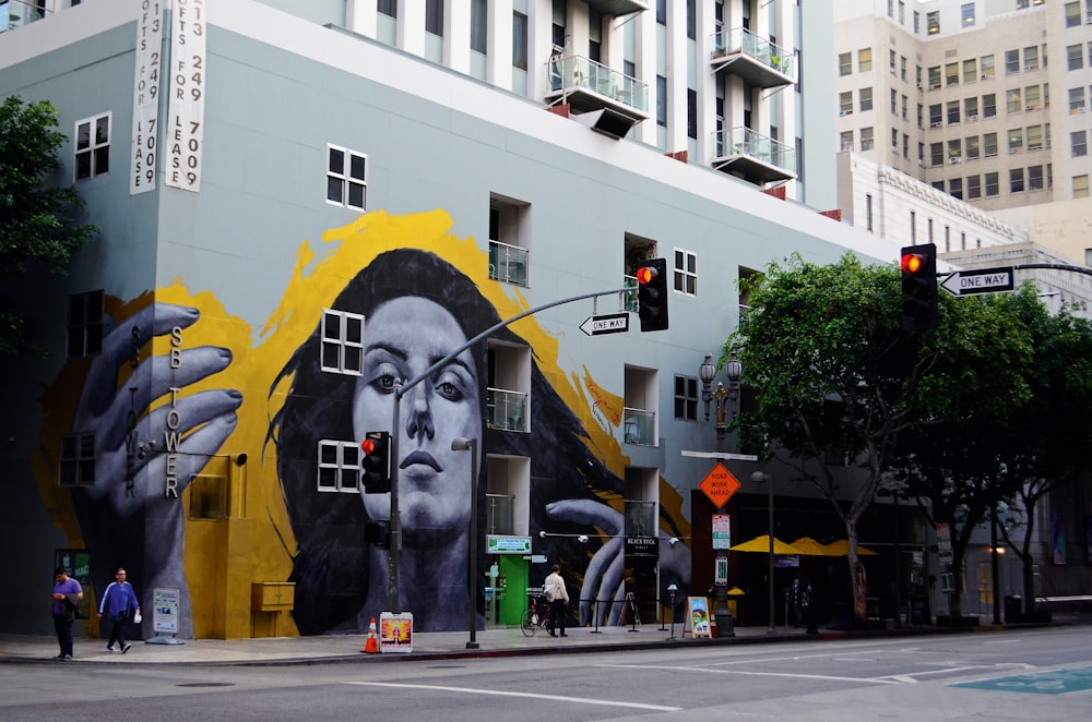 painted wall building near a road during daytime