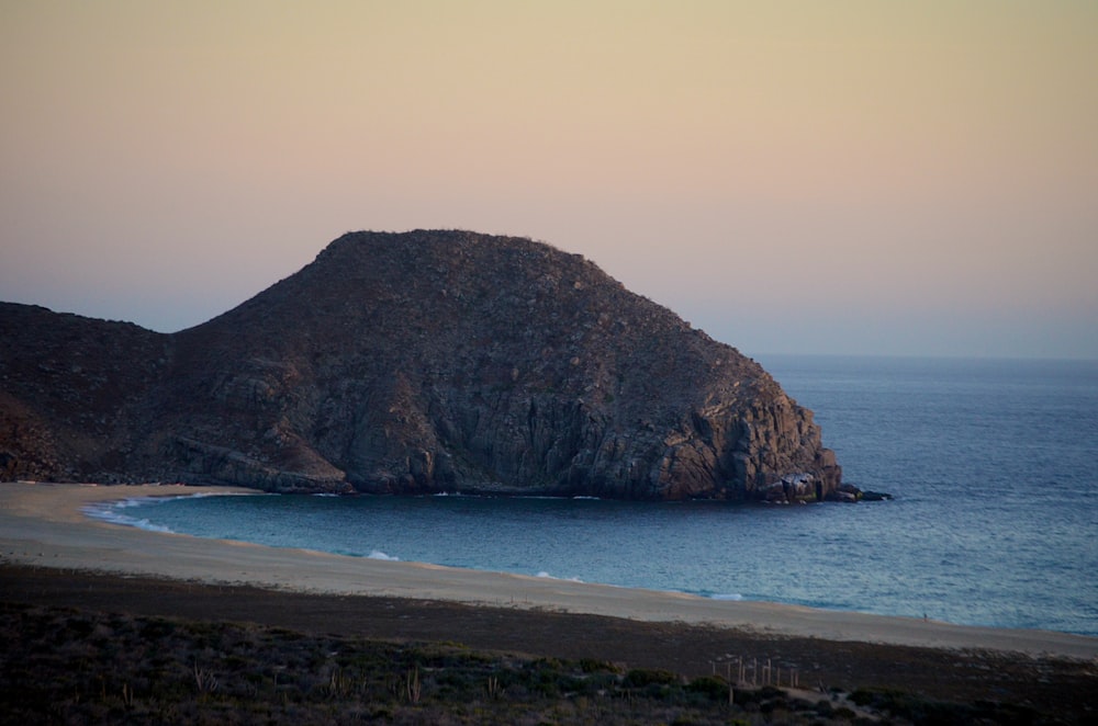 mountain by the sea during daytime