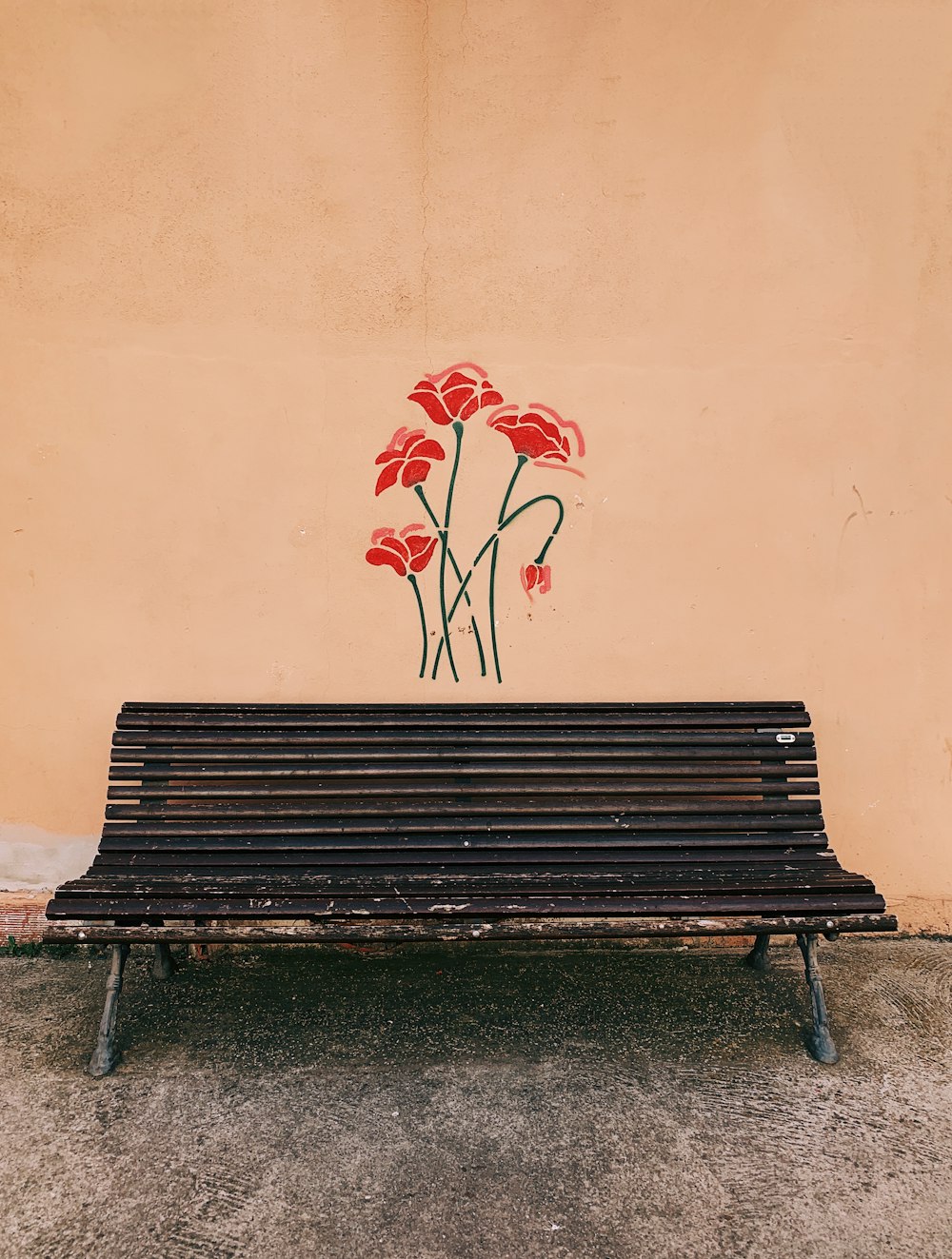 brown wooden bench near brown wall