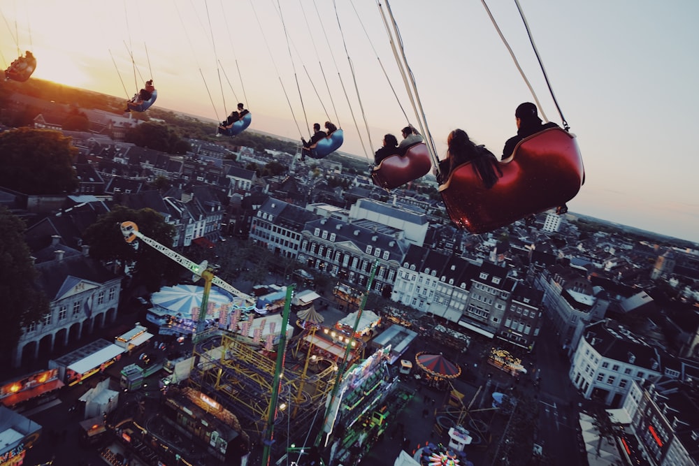 people riding on swing during daytime