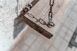 Close-up of chemical anchor grouting being applied to a beam.