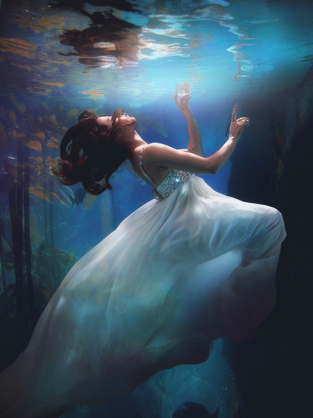 underwater photography of woman wearing white dress