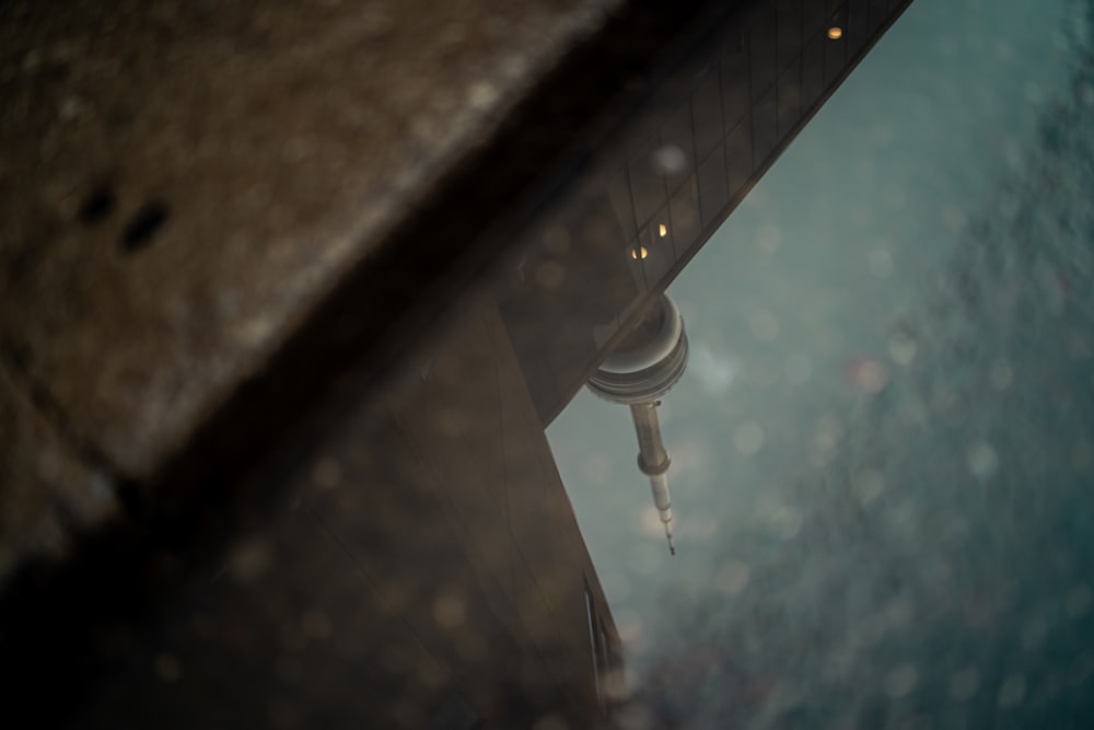 a reflection of a building in a puddle of water