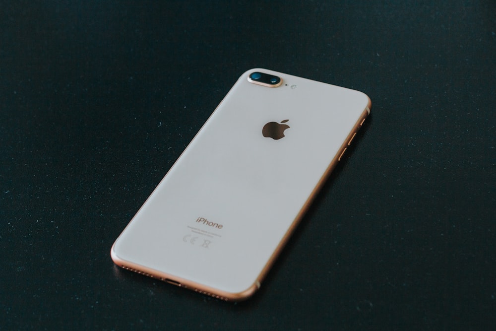 gold iPhone 7 Plus on black surface