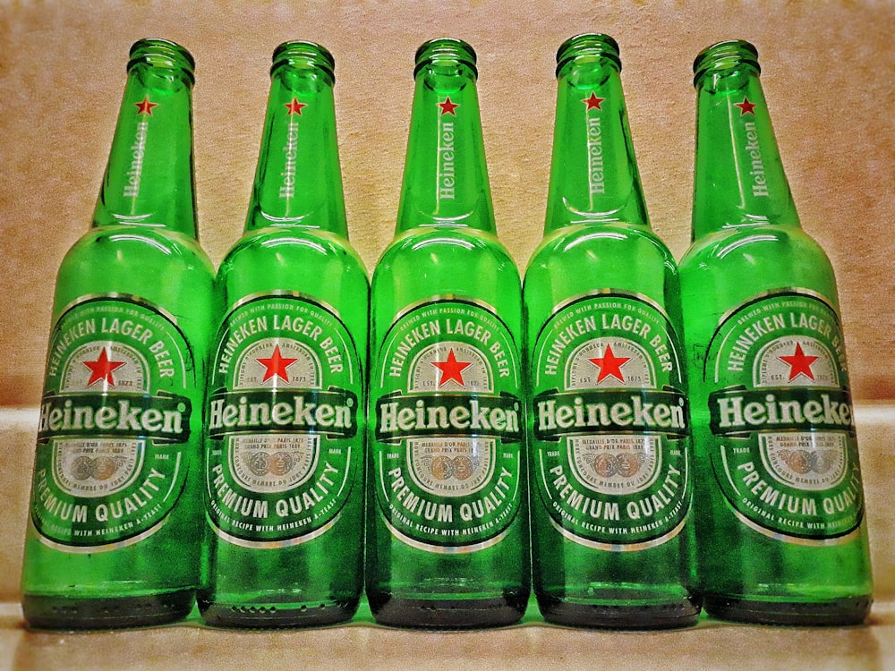 five Heineken beer bottles