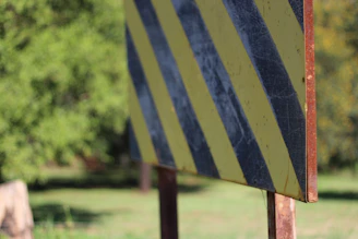 Custom safety signs installed outdoors, clearly marking hazards with bold colors.