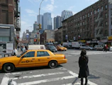 A bustling New York City street with yellow taxis and skyscrapers on a sunny day