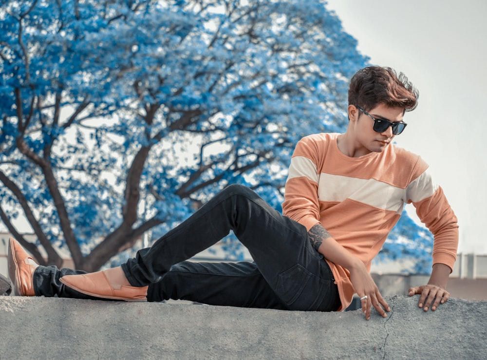 shallow focus photo of man in brown crew-neck long-sleeved shirt and black pants