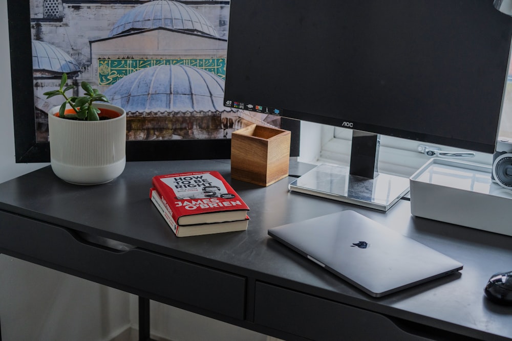 silver MacBook on black wooden table