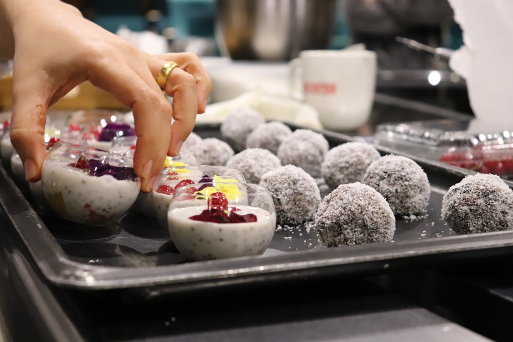 person picking dessert from tray