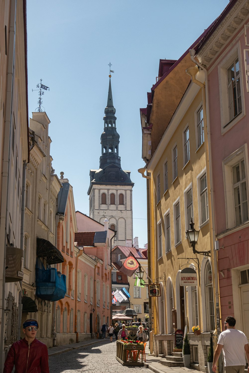 people walking on road between buildings