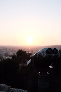 A hand holding a felitwo coin against a city skyline at sunset, symbolizing movement and aspiration.