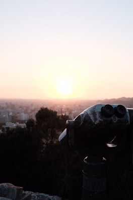 A dynamic shot of a person holding a felitwo coin against a city skyline at dusk.