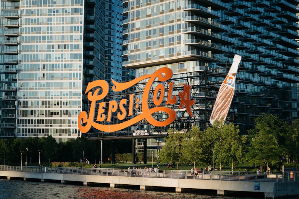 Pepsi-Cola signage near body of water
