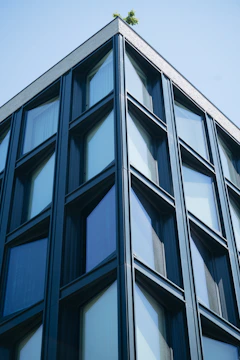 A commercial building facade with clean lines and sustainable green roofing.