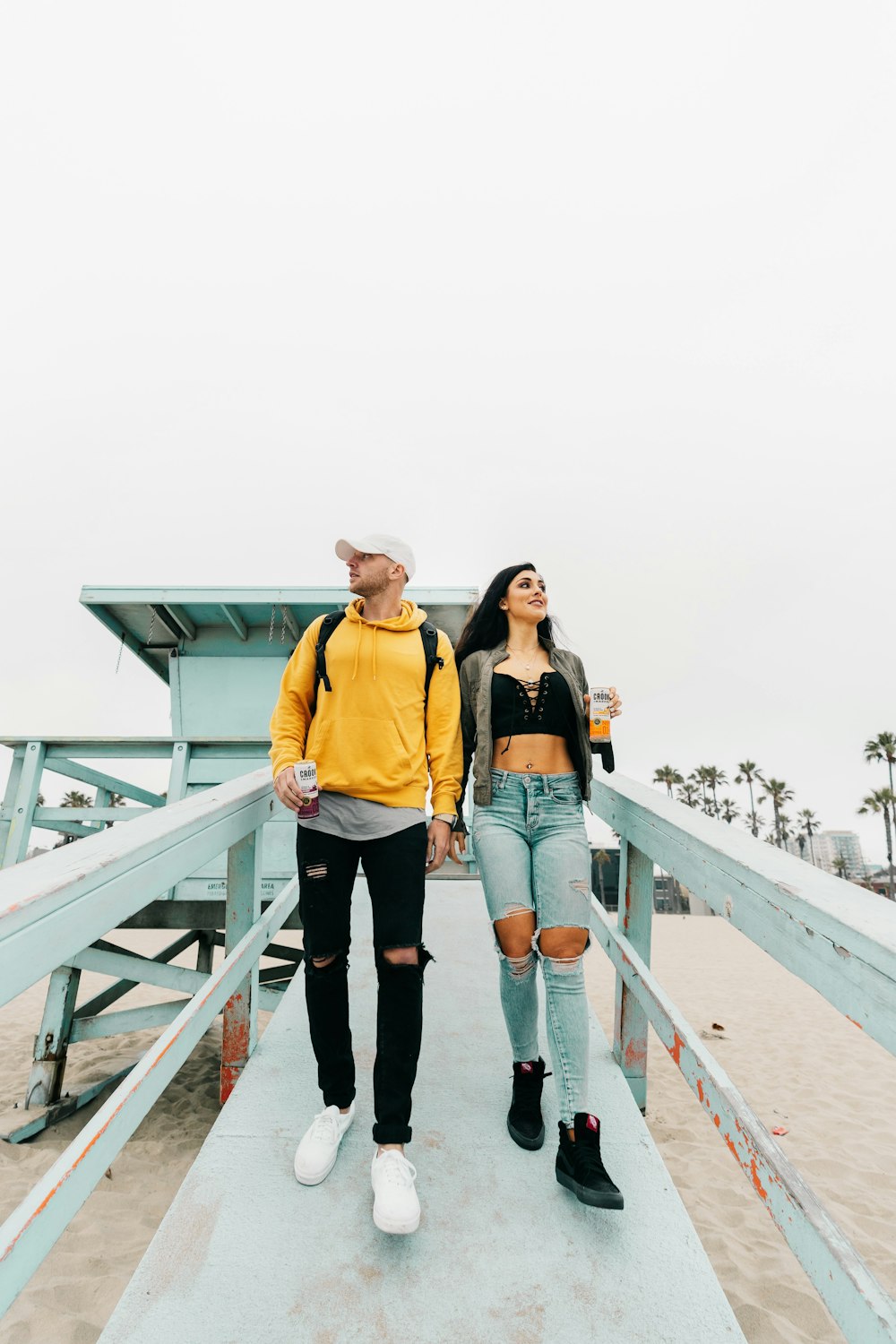 man and woman standing on lifeguard house