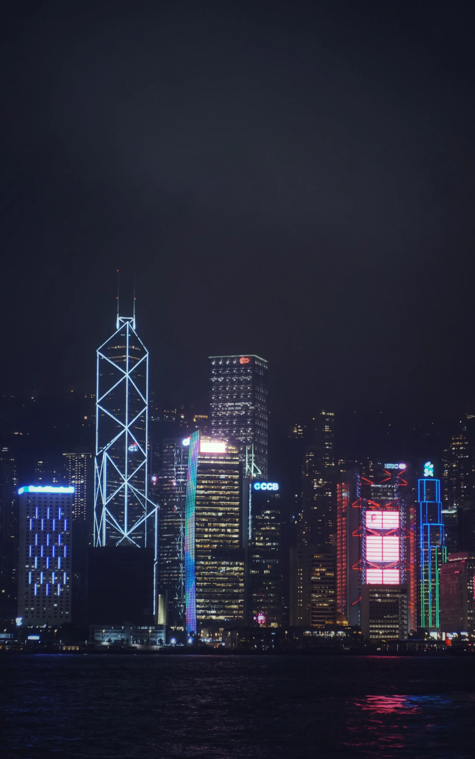 Hong Kong skyline illuminated across Victoria Harbour at night