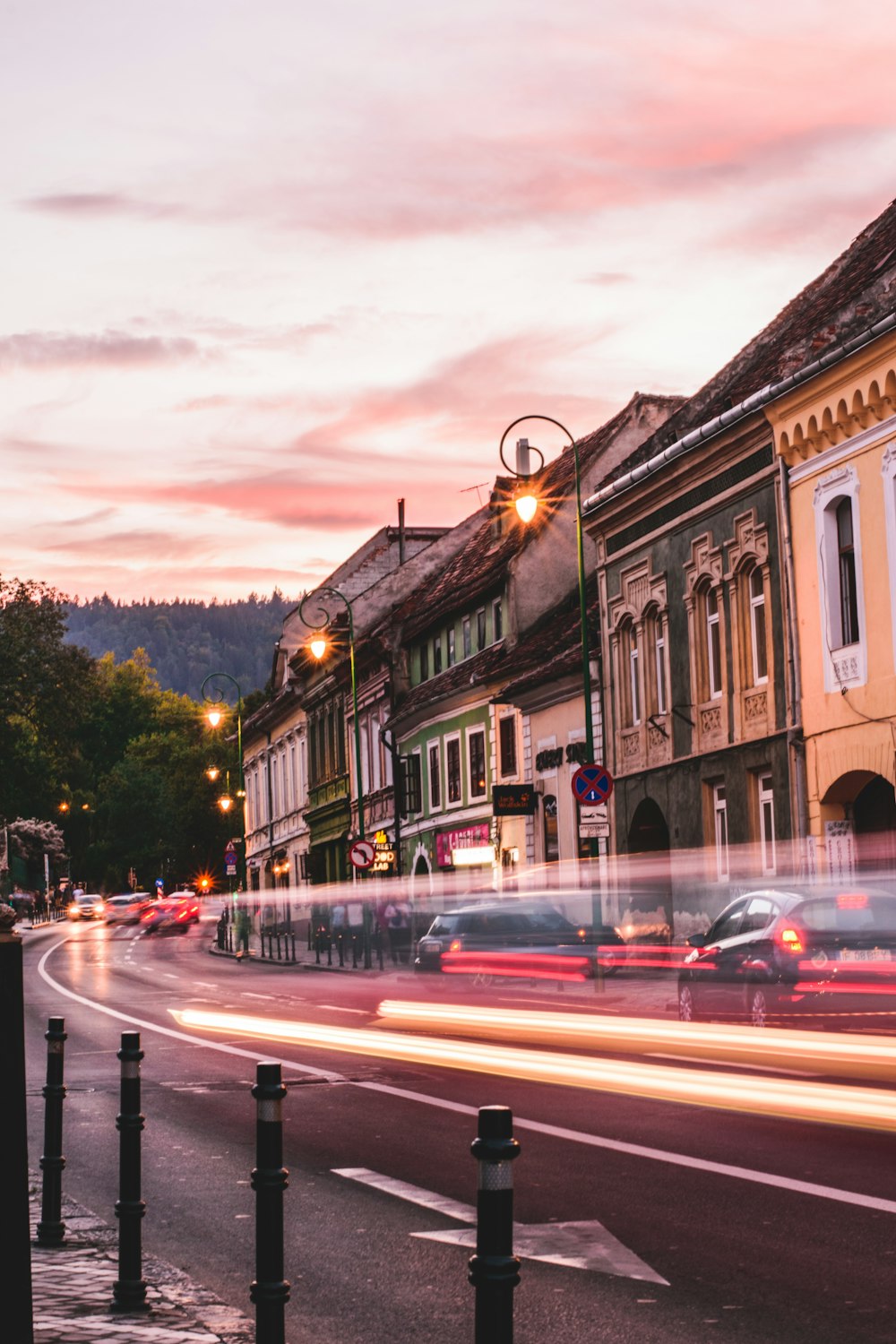 time lapse photography of cars passing beside building