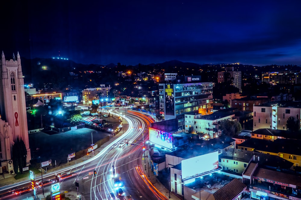 streaking lights from cars travelling on highway during nighttime