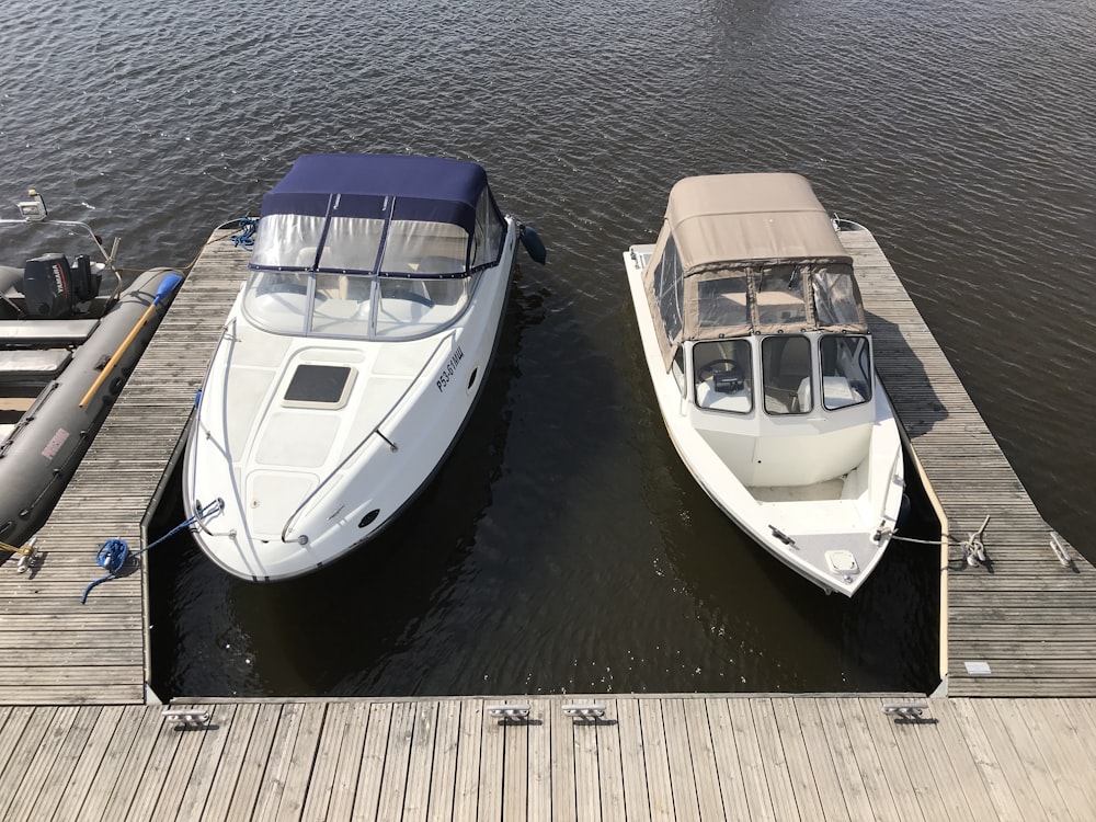 white boats on pier