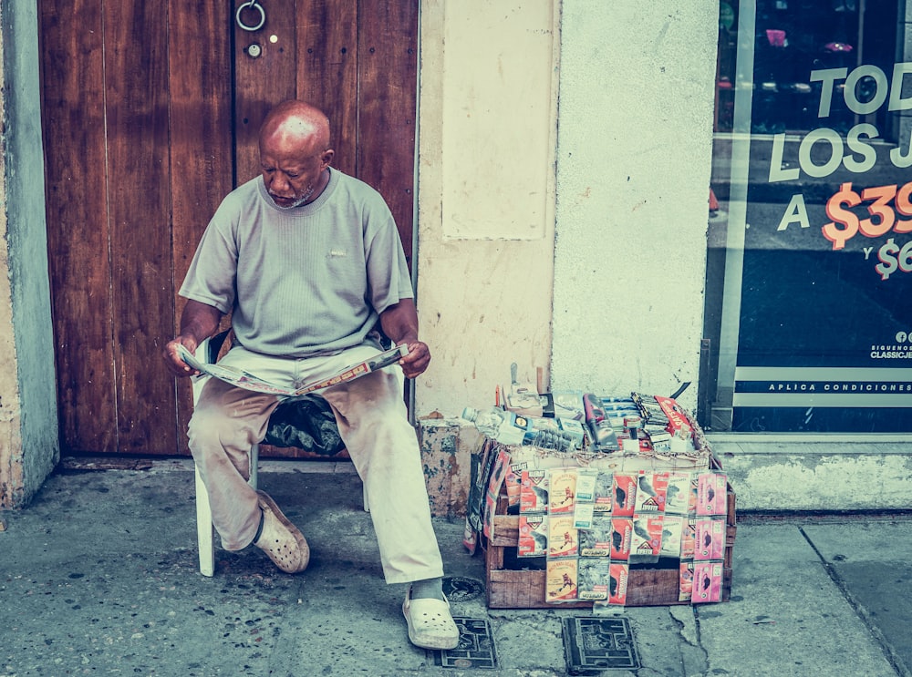 man reading newspaper near door