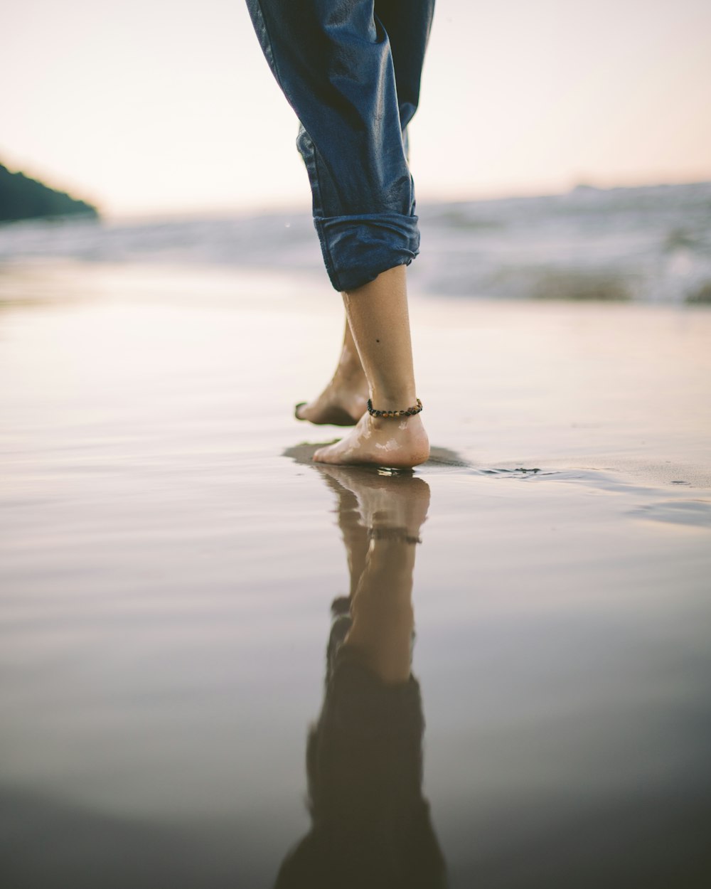 person walking on beach