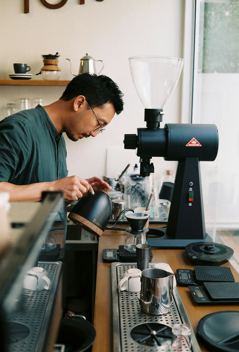 man pouring tea on cup