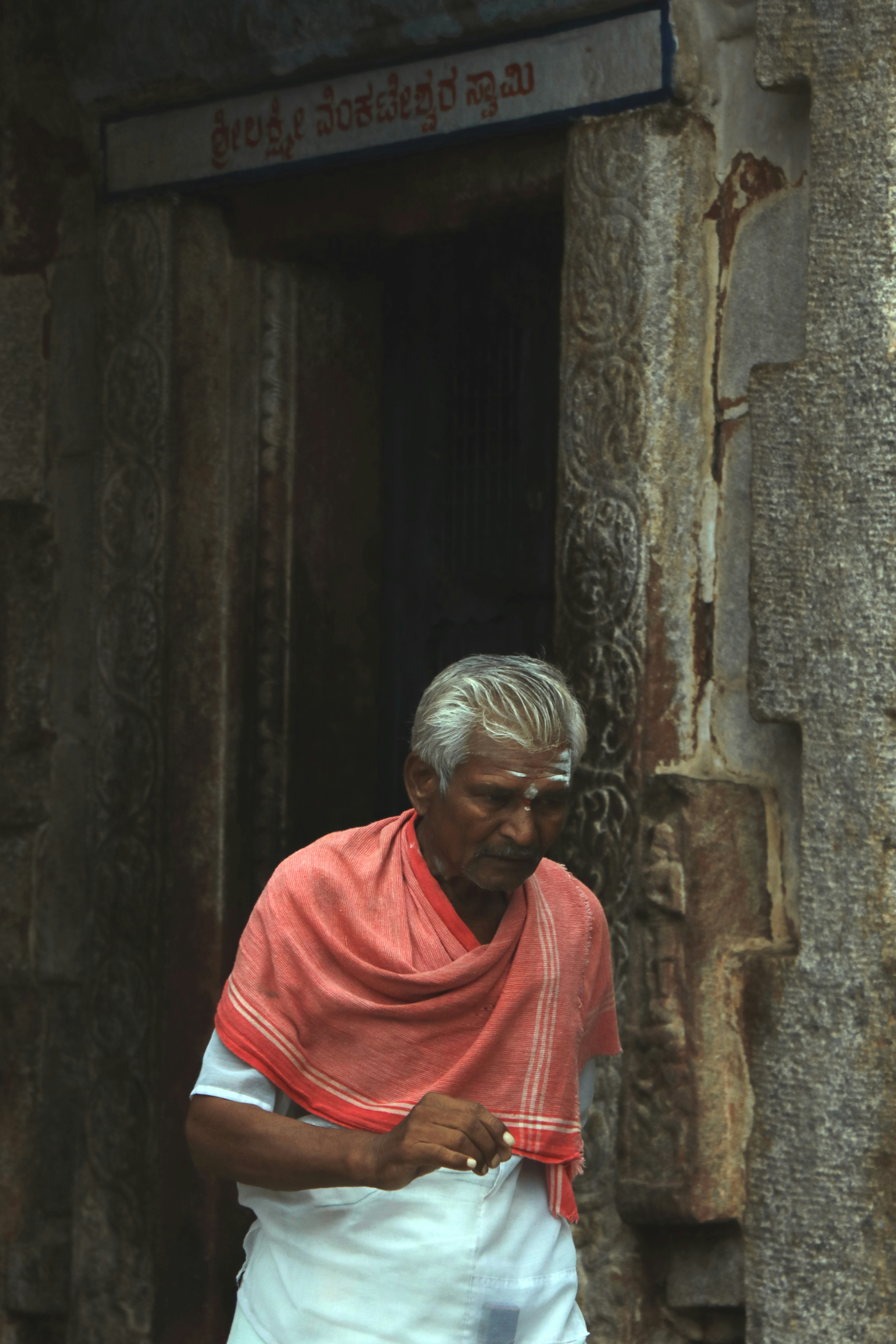 man walking near brown wall
