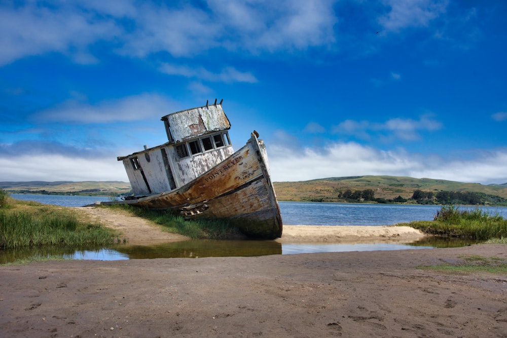 white boat in body of water during daytime