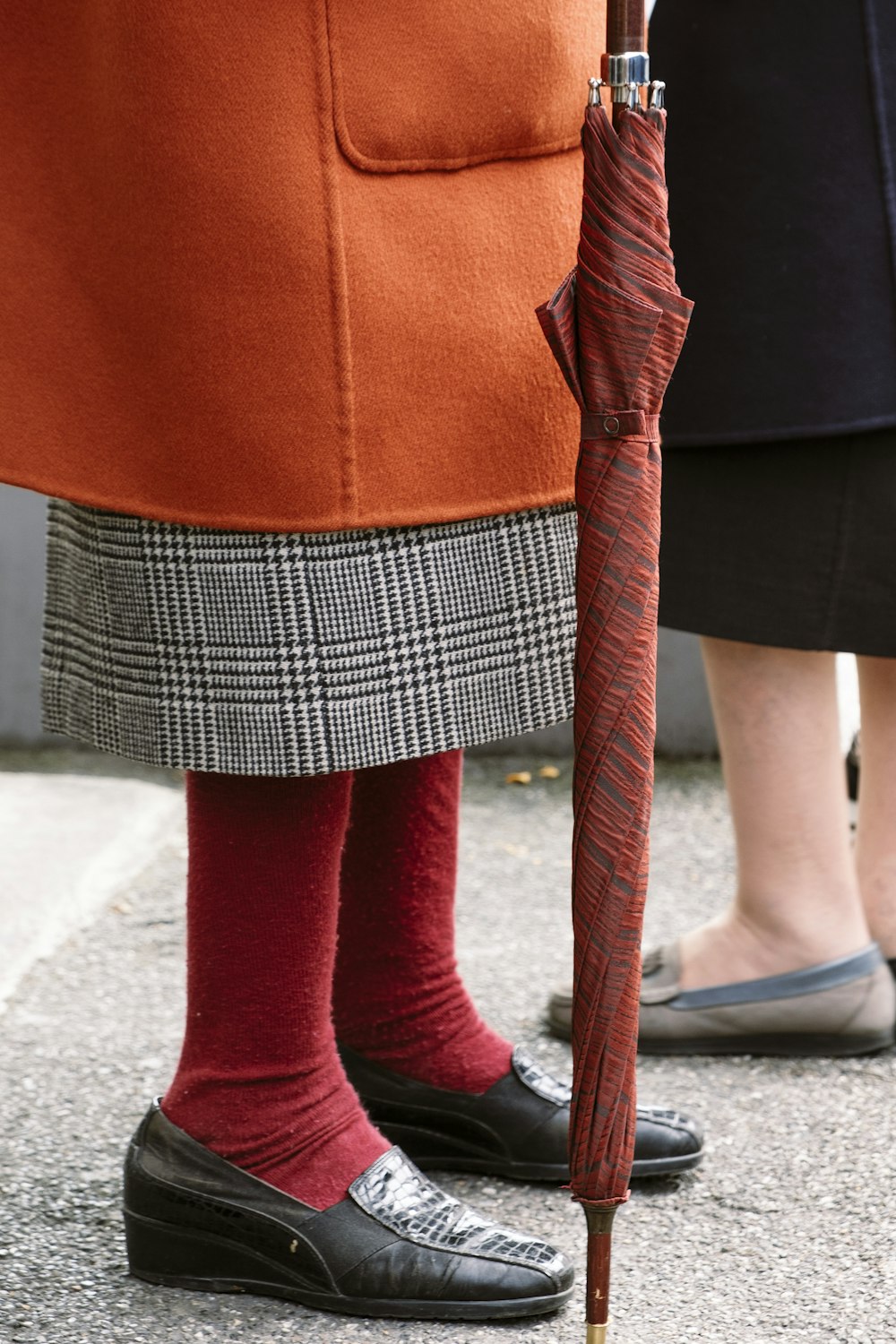 person holding red folding umbrella