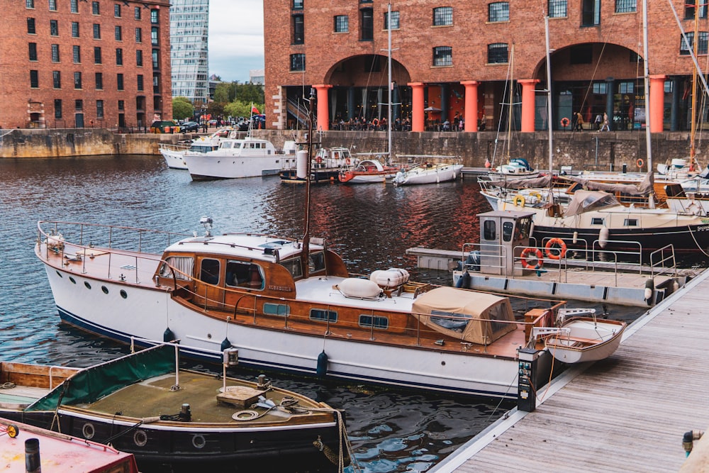 white and brown boat on boatyard