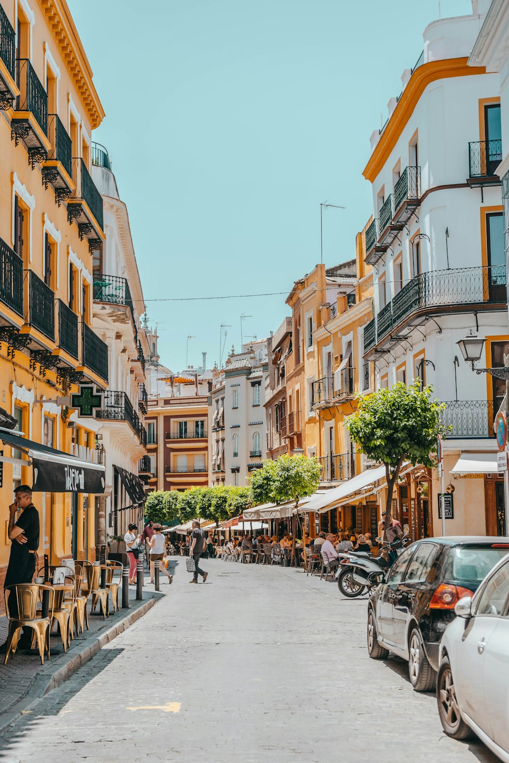 people walking between buildings during daytime