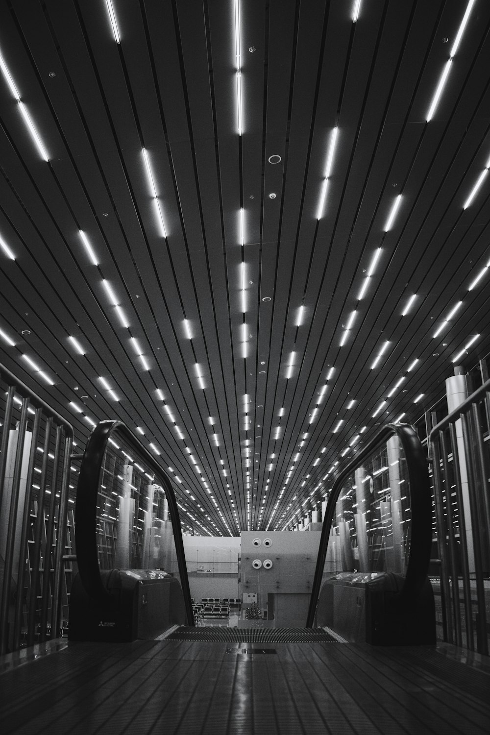 grayscale photo of escalator