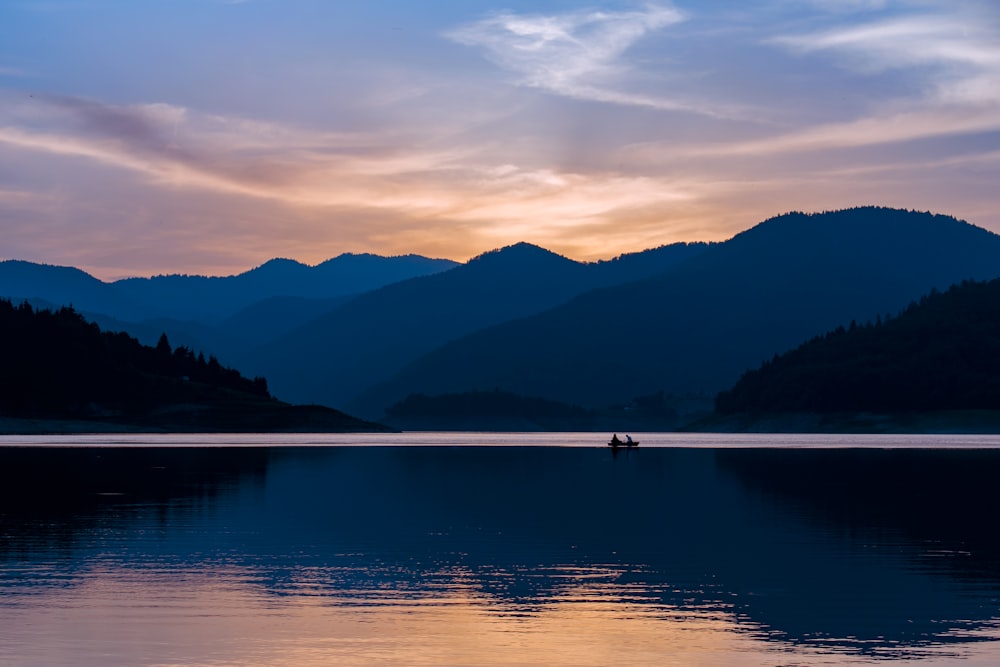 panoramic photography of boat on body of water during golden hour