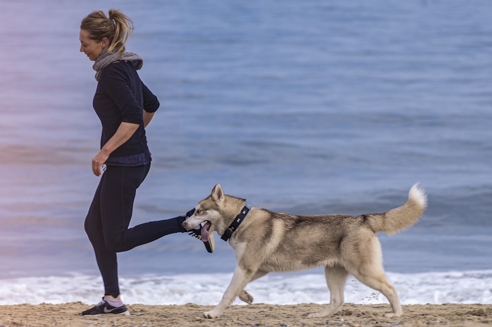 woman and dog on seashore