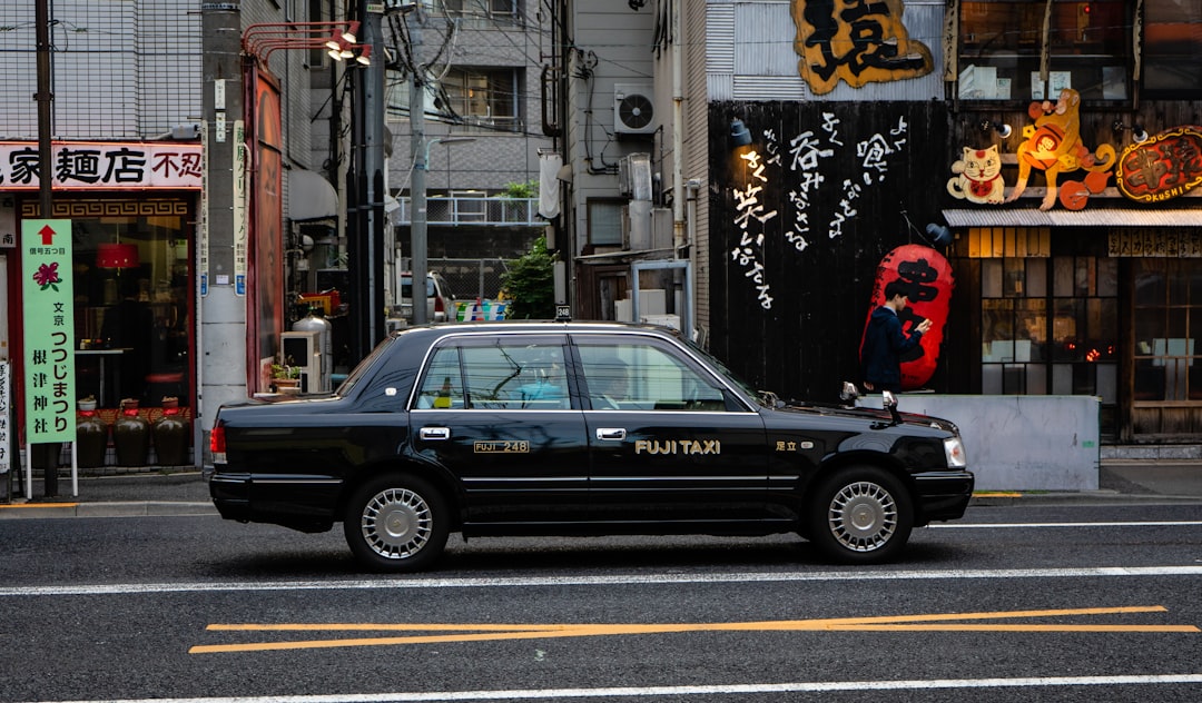 black Fuji Taxi cab in street